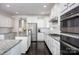 Modern kitchen with stainless steel appliances, granite countertops, and dark hardwood floors at 990 Nw Capwalk Nw Rd # 138, Concord, NC 28027