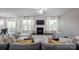 Bright living room with fireplace, large windows, elegant drapes, and stylish, comfortable seating at 990 Nw Capwalk Nw Rd # 138, Concord, NC 28027