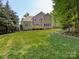 Large backyard featuring lush lawn and an elevated wooden deck at 10716 Meg Meadow Dr, Mint Hill, NC 28227