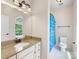 Well-lit bathroom with granite counters, white cabinets, and a window providing natural light at 10716 Meg Meadow Dr, Mint Hill, NC 28227
