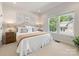 Bright bedroom with neutral decor, featuring large windows offering a pleasant outdoor view at 10716 Meg Meadow Dr, Mint Hill, NC 28227
