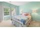 Charming bedroom featuring a colorful quilt, natural light, and stylish decor at 10716 Meg Meadow Dr, Mint Hill, NC 28227
