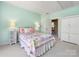 Bright bedroom featuring colorful bedding, natural light, and fresh interior paint at 10716 Meg Meadow Dr, Mint Hill, NC 28227