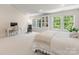 Spacious bedroom showcasing natural light, a work space, and a large comfortable bed at 10716 Meg Meadow Dr, Mint Hill, NC 28227