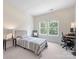 Bright bedroom with desk and chair next to a window and a twin size bed at 10716 Meg Meadow Dr, Mint Hill, NC 28227