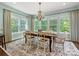 Dining room with large windows offering backyard view, chandelier and hardwood floors at 10716 Meg Meadow Dr, Mint Hill, NC 28227
