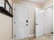 Entryway with tile flooring, mirror and coat rack next to the door that leads to the hallway at 10716 Meg Meadow Dr, Mint Hill, NC 28227