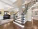 Grand foyer with hardwood floors, staircase, and a piano room featuring a Yamaha piano at 10716 Meg Meadow Dr, Mint Hill, NC 28227
