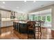 Open concept kitchen with island, stainless steel appliances, granite counters and breakfast area at 10716 Meg Meadow Dr, Mint Hill, NC 28227