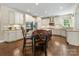 Spacious kitchen features hardwood floors, granite countertops, stainless steel appliances, and white cabinets at 10716 Meg Meadow Dr, Mint Hill, NC 28227