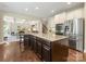 Kitchen island features stainless steel appliances, granite countertops and hardwood flooring at 10716 Meg Meadow Dr, Mint Hill, NC 28227