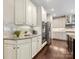 Kitchen with stainless steel appliances, granite counters, white cabinets, and hardwood flooring at 10716 Meg Meadow Dr, Mint Hill, NC 28227