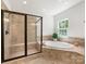 Main bathroom features a tiled shower with glass door and soaking tub at 10716 Meg Meadow Dr, Mint Hill, NC 28227