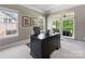 Bright home office with large windows, a spacious desk, and neutral carpet at 10716 Meg Meadow Dr, Mint Hill, NC 28227