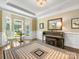 Sunlit piano room with hardwood floors, large windows, and a classic Yamaha piano at 10716 Meg Meadow Dr, Mint Hill, NC 28227