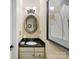 Elegant powder room featuring a granite countertop and a decorative oval mirror at 10716 Meg Meadow Dr, Mint Hill, NC 28227