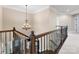 A beautiful staircase with decorative wrought iron bannister and detailed wood trim at 10716 Meg Meadow Dr, Mint Hill, NC 28227