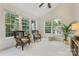 Bright sun room with vaulted ceilings, neutral paint, and lots of natural light from large windows at 10716 Meg Meadow Dr, Mint Hill, NC 28227