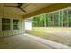 This stylish single-story home features an outdoor patio with ceiling fan overlooking a spacious private back yard at 108 Woodwinds St, Locust, NC 28097