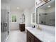 Bright bathroom with dual vanities, walk-in shower, and modern finishes at 108 Woodwinds St, Locust, NC 28097