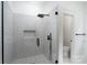 Modern bathroom featuring a glass-enclosed shower with sleek, black fixtures at 108 Woodwinds St, Locust, NC 28097