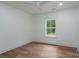 Bright bedroom featuring wood flooring, a window, and neutral paint, creating a calming retreat at 108 Woodwinds St, Locust, NC 28097
