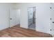 Cozy bedroom with hardwood floors, complemented by fresh paint and access to an ensuite bathroom at 108 Woodwinds St, Locust, NC 28097