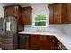 Close up of kitchen featuring custom cabinetry, stainless steel appliances, and white countertops at 108 Woodwinds St, Locust, NC 28097