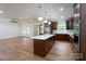 Open concept kitchen featuring an island, stainless steel appliances, and hardwood floors at 108 Woodwinds St, Locust, NC 28097
