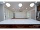 Bright and airy living room with hardwood floors, white walls and modern lighting at 108 Woodwinds St, Locust, NC 28097