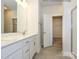 Modern bathroom with double vanity, tile floors, and a glass-enclosed shower at 1112 Bismuth Ln, Charlotte, NC 28211