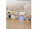 Spacious open-concept living area featuring hardwood floors, recessed lighting, and natural light at 1112 Bismuth Ln, Charlotte, NC 28211