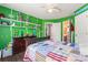 The bedroom has green walls, painted numbers like a football field, and a ceiling fan at 125 N Wendover Trce, Mooresville, NC 28117