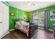 The bedroom has green walls, painted numbers like a football field, and a ceiling fan at 125 N Wendover Trce, Mooresville, NC 28117