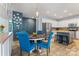 Inviting dining room with stylish blue chairs, pendant lighting, and a view into the modern kitchen at 125 N Wendover Trce, Mooresville, NC 28117
