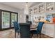 Elegant dining area with stylish blue chairs, view to living room, and exterior access at 125 N Wendover Trce, Mooresville, NC 28117