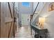 Bright foyer with barn door, hardwood floors, staircase, and decorative table lamp, creating a warm entrance at 125 N Wendover Trce, Mooresville, NC 28117