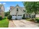 Inviting two-story home with a two car garage, basketball hoop, well-manicured lawn, and a covered porch at 125 N Wendover Trce, Mooresville, NC 28117