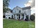 Charming two-story home with a beautifully landscaped front yard and welcoming front porch with columns at 125 N Wendover Trce, Mooresville, NC 28117