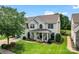 Beautiful two-story home with lush lawn, mature trees, and inviting front porch with decorative columns at 125 N Wendover Trce, Mooresville, NC 28117