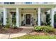 Inviting front porch featuring classic columns, hanging plants, and a decorative door, creating a welcoming entrance at 125 N Wendover Trce, Mooresville, NC 28117