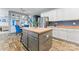 Kitchen island with stainless steel appliances and custom wood flooring and cabinets at 125 N Wendover Trce, Mooresville, NC 28117