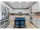 Well lit eat-in kitchen with large center island, stainless steel appliances and beautiful flooring at 125 N Wendover Trce, Mooresville, NC 28117