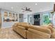 Inviting living room with fireplace, a large sectional sofa, and open access to the kitchen and dining area at 125 N Wendover Trce, Mooresville, NC 28117