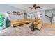 Cozy living room featuring a large sectional sofa, tiled floors, and a neutral color scheme at 125 N Wendover Trce, Mooresville, NC 28117