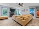 Comfortable living room featuring a fireplace, large sectional sofa, and adjacent views into office at 125 N Wendover Trce, Mooresville, NC 28117