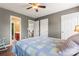 Bedroom featuring gray walls, ceiling fan, views into ensuite bathroom, and wood flooring at 125 N Wendover Trce, Mooresville, NC 28117