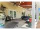 Inviting covered patio featuring a ceiling fan, seating area, grill, and access to the backyard at 125 N Wendover Trce, Mooresville, NC 28117