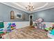 Spacious playroom featuring chandelier, hardwood floors, toys, and decorations, perfect for activities at 125 N Wendover Trce, Mooresville, NC 28117