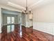 Bright dining room with hardwood floors, coffered ceiling, and access to the kitchen at 13237 Fremington Rd, Huntersville, NC 28078